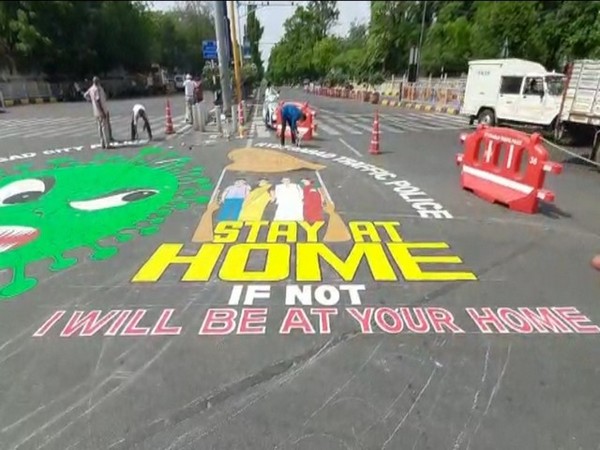 An artist creates graffiti on road to spread awareness about lockdown in Hyderabad