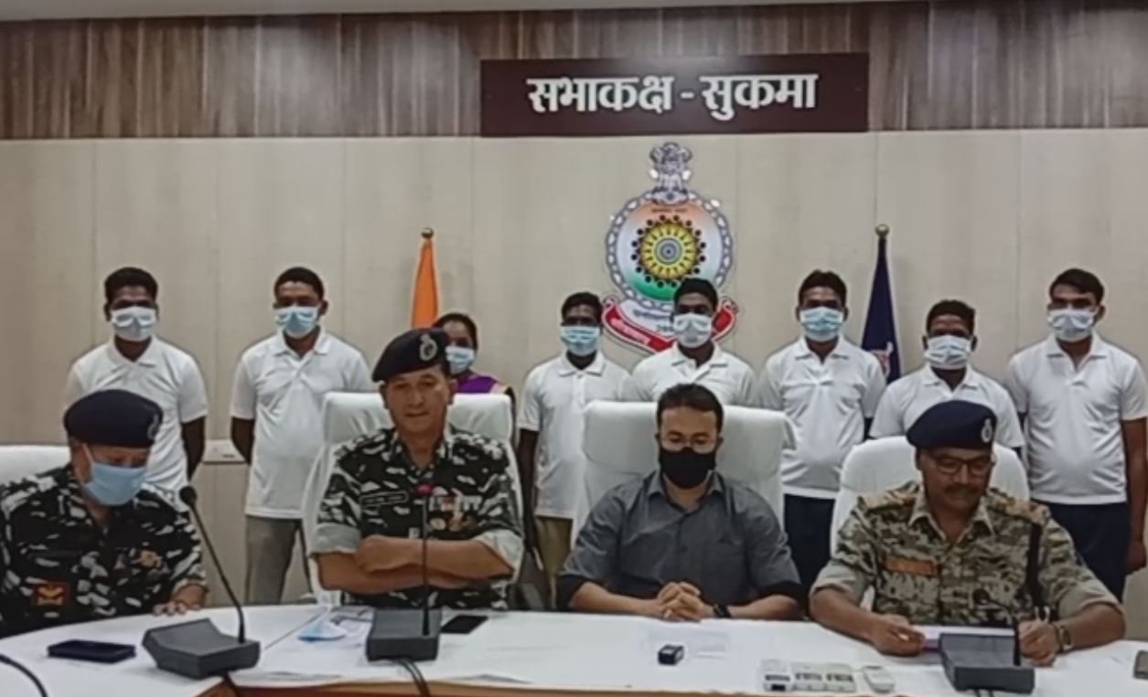 Officials address the media with the arrested Naxals in the background