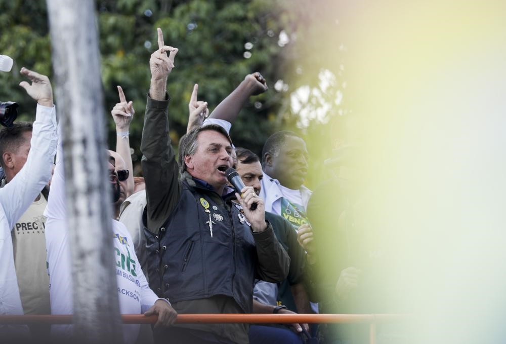 Brazil's President Jair Bolsonaro talks to supporters