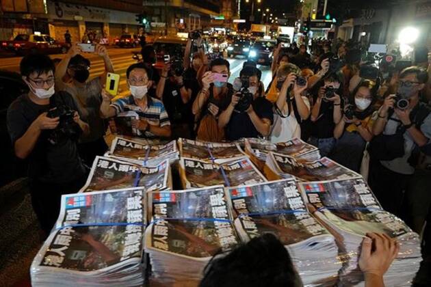 Media personnel clicking picture of Apple Daily newspaper