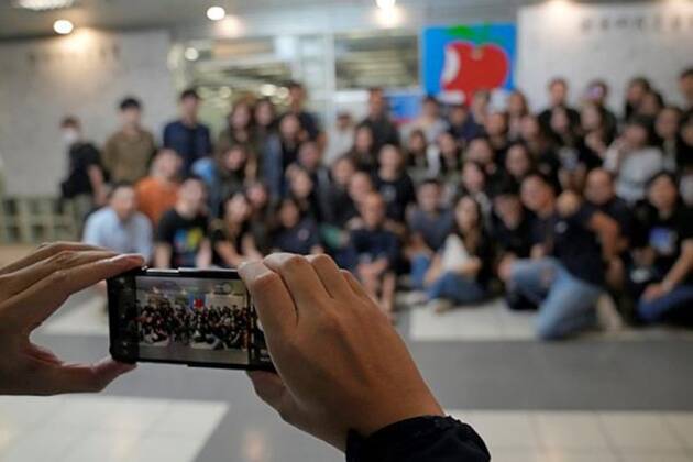 Team members of  Apple Daily newspaper