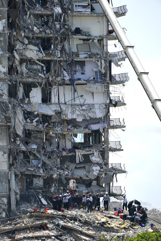 A South Florida Urban Search and Rescue team looks for survivors at the 12-story oceanfront condo, Champlain Towers South, Saturday, June 26, 2021, that partially collapsed early Thursday in the town of Surfside, Fla.