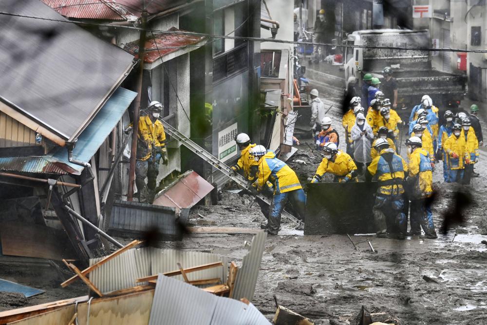 Rescuers conduct a search operation at the site of a mudslide at Izusan in Atami, Shizuoka prefecture, southwest of Tokyo