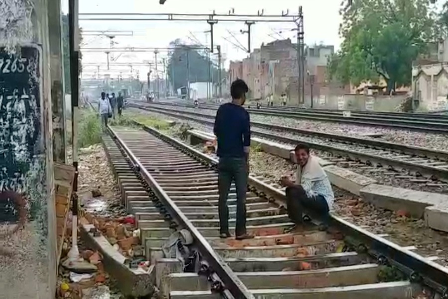 people walking railway crossing