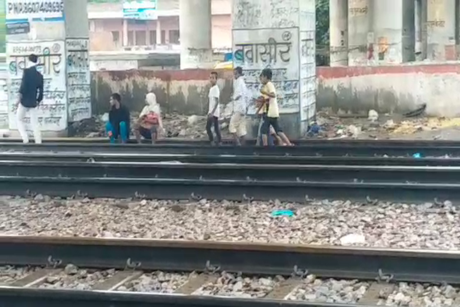 people walking railway crossing