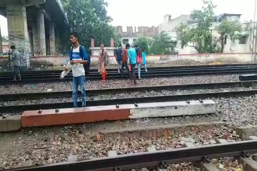 people walking railway crossing