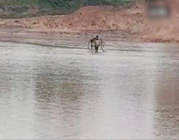 Villagers crossed overflowing river