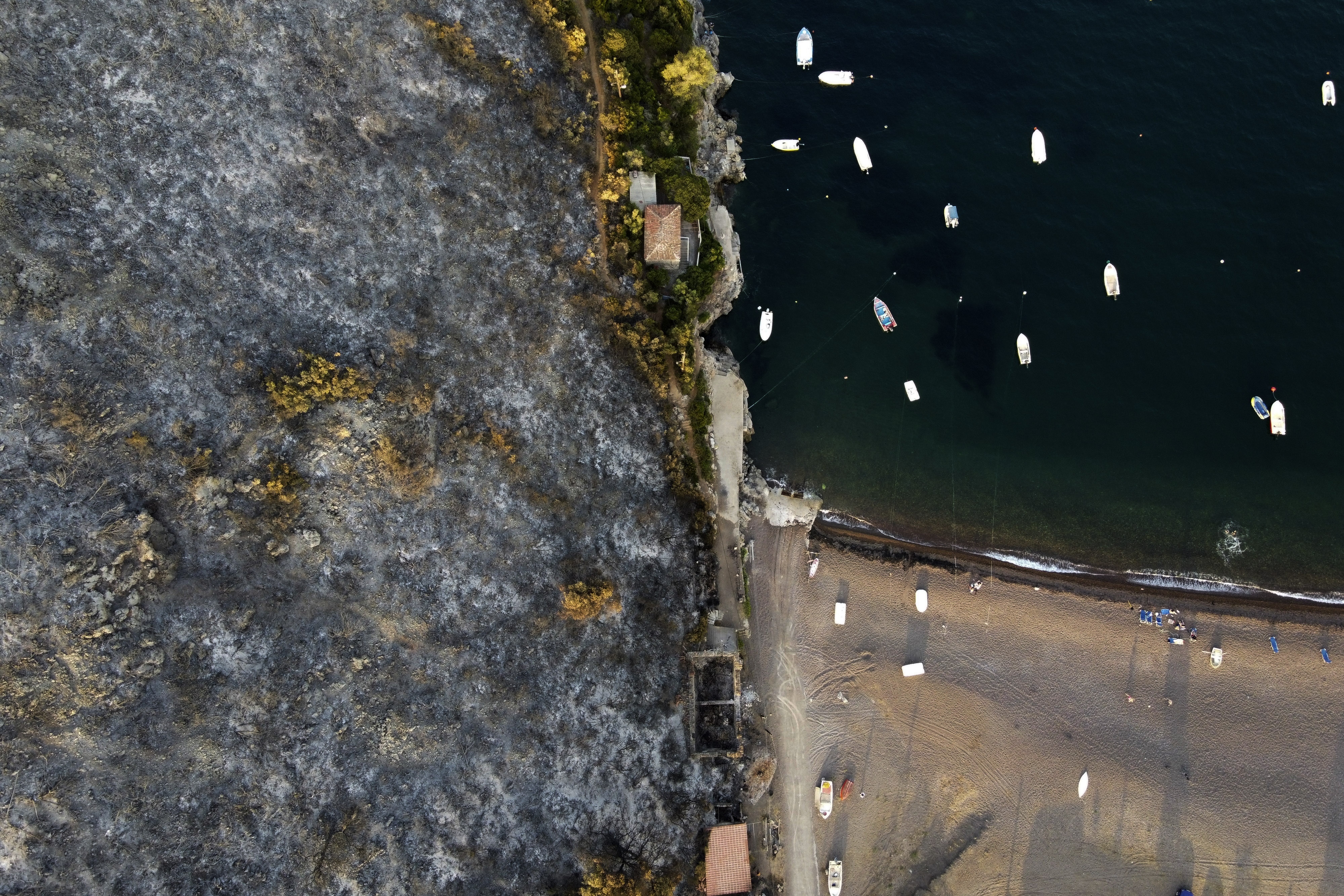 A burnt mountain over a beach in Agia Anna