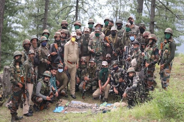 Security forces pose with seized arms