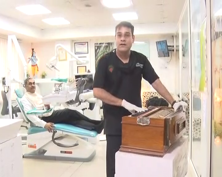 Doctor Prashant playing harmonium during treatment