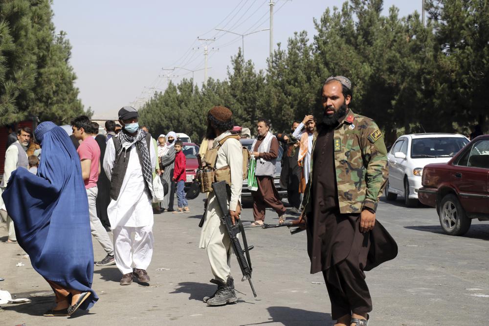 Taliban fighters stand guard outside the airport after Thursday's deadly attacks, in Kabul, Afghanistan, Friday, Aug. 27, 2021. Two suicide bombers and gunmen attacked crowds of Afghans flocking to Kabul's airport Thursday, transforming a scene of desperation into one of horror in the waning days of an airlift for those fleeing the Taliban takeover.