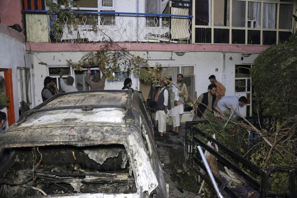 Afghan people are seen inside a house after U.S. drone strike in Kabul.