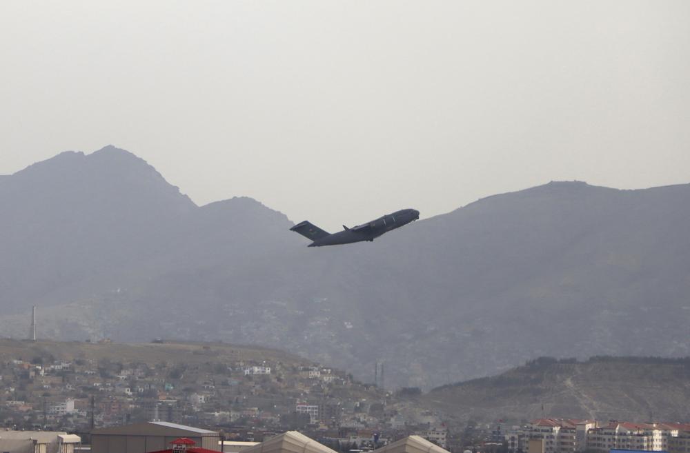 A U.S military aircraft takes off from the Hamid Karzai International Airport in Kabul, Afghanistan, Monday, Aug. 30, 2021. (AP Photo/Wali Sabawoon)