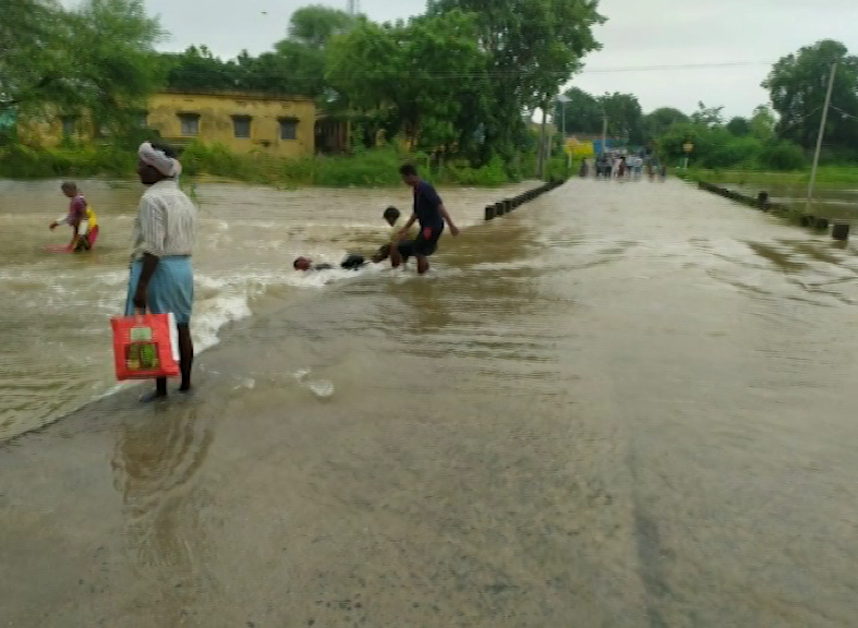 Floods in warangal, youth saved mother and son