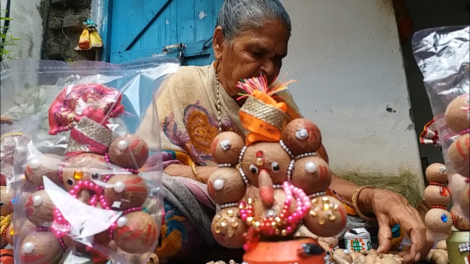 Elderly woman making idol of Lord Ganesha