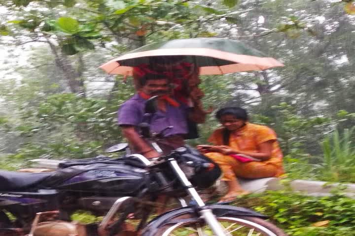 father holds umbrella for daughter's studies