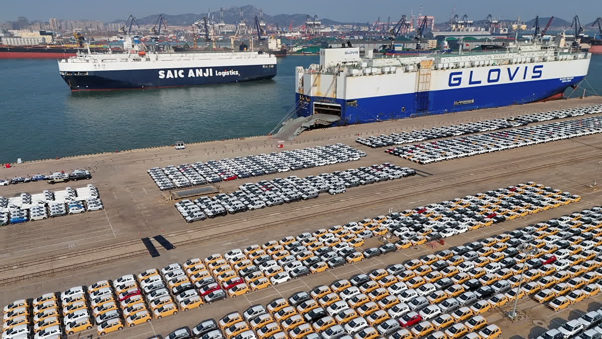 Vehicles and trucks for export wait for transportation from a port in Yantai in eastern China's Shandong province on Jan. 2, 2025.