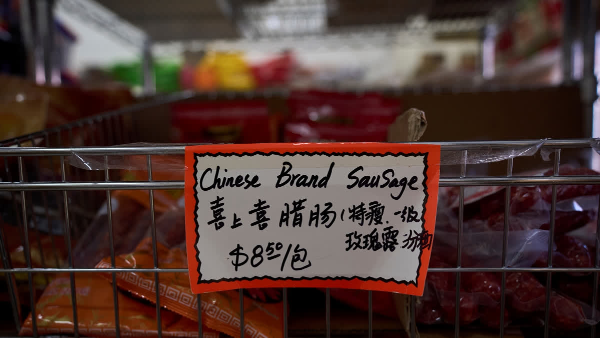A handwritten price tag for sausage imported from China is seen at a grocery market in the Chinatown neighborhood of Los Angeles, Friday, April 11, 2025.