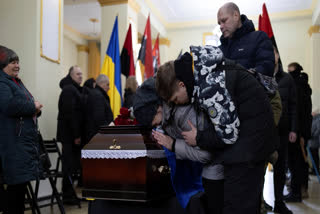 Mother and brother cry at the coffin of Ukrainian soldier Oleksandr Samoilovich, 18, of 1st Separate Assault Regiment of Dmytro Kotsiubailo, during farewell ceremony in Slavuta, Ukraine, Friday, April 11, 2025.