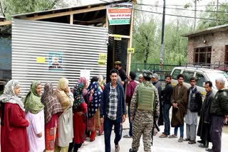Voters queue up to cast their vote at a polling booth for the fourth phase of the Lok Sabha election, in Srinagar on Monday May 13