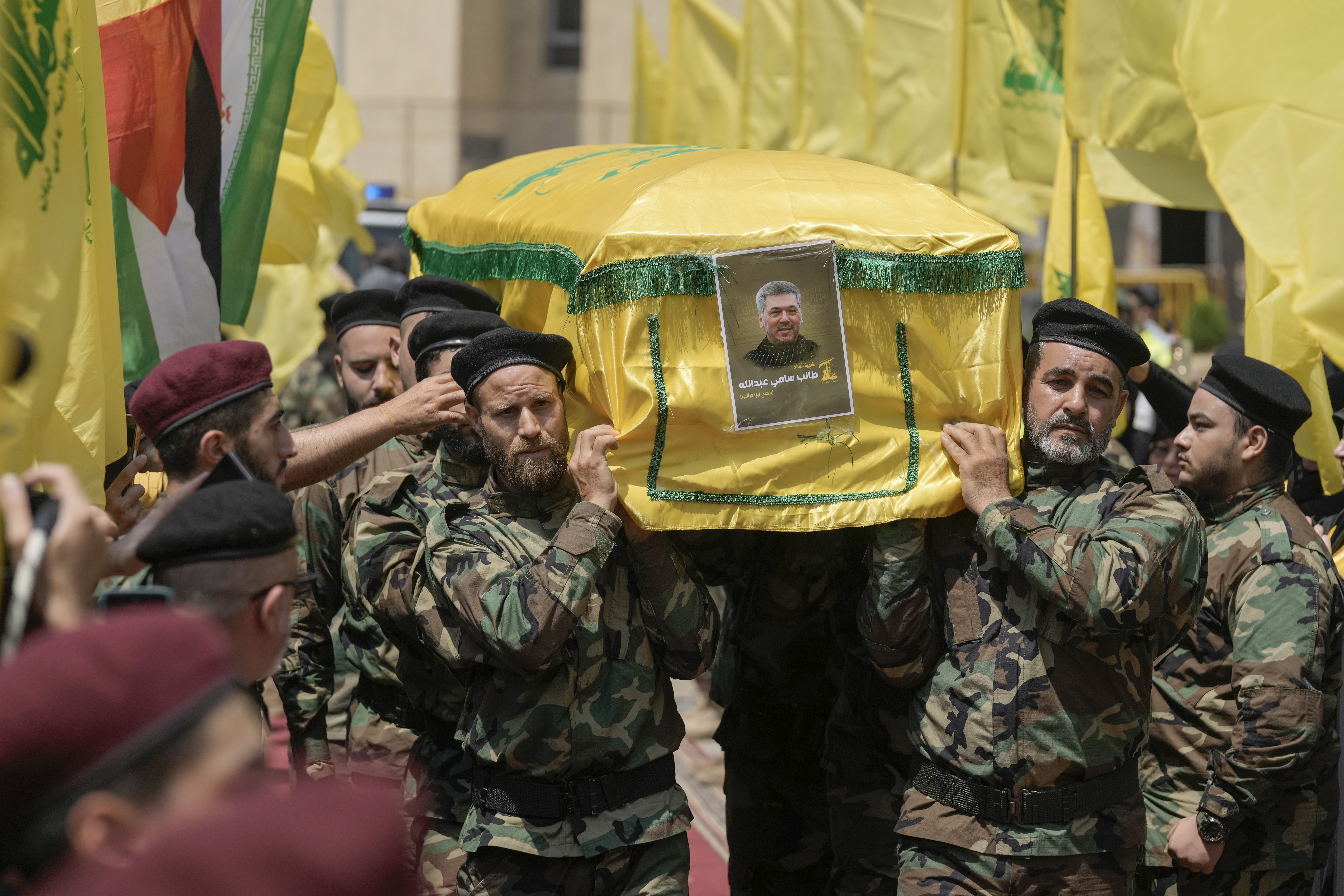 Hezbollah fighters carry the coffin of their comrade, senior commander Taleb Sami Abdullah