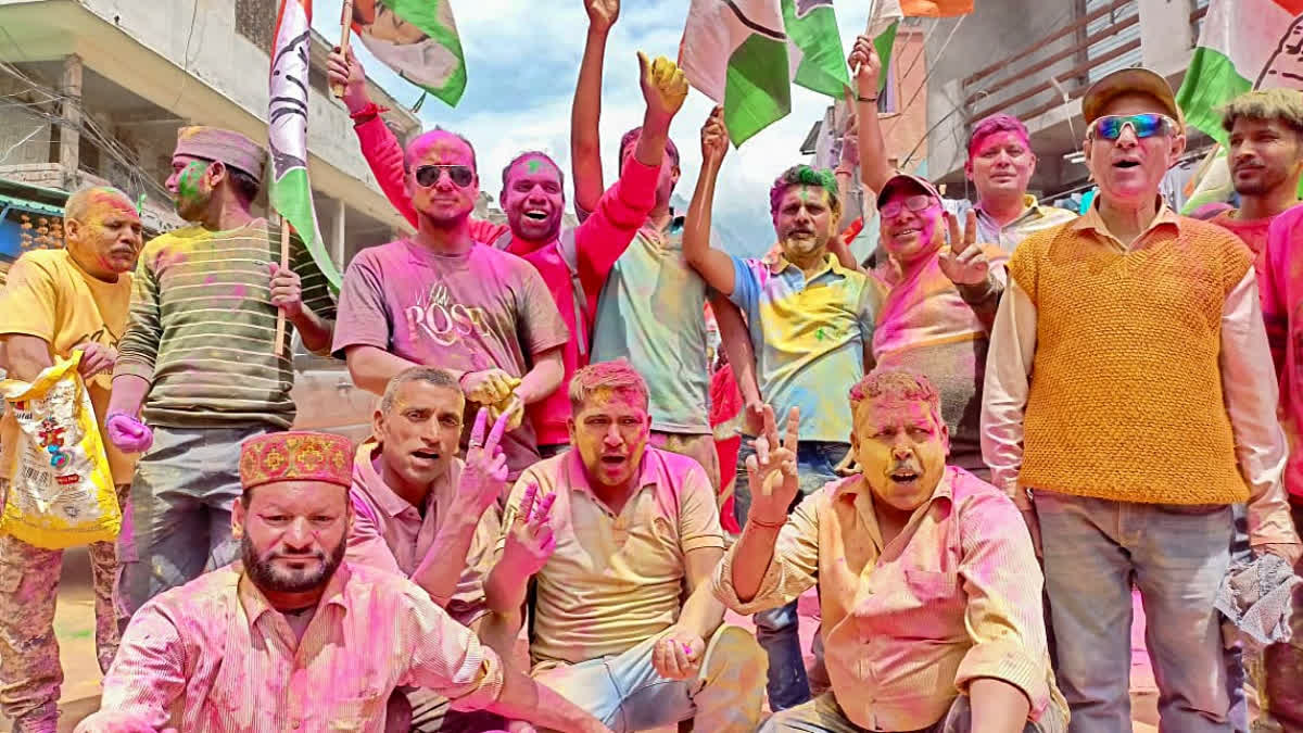 Congress workers celebrate after the victory of party candidate Lakhapat Singh Butola in the Badrinath Assembly by-poll election, in Uttarakhand on Saturday.