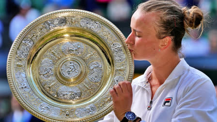 Barbora Krejcikova of the Czech Republic kisses her trophy after defeating Jasmine Paolini of Italy in the women's singles final at the Wimbledon tennis championships in London, Saturday, July 13, 2024.