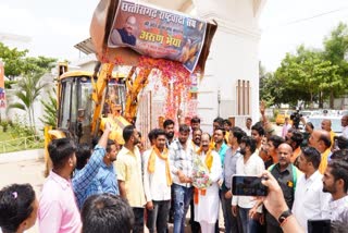 Bulldozer showering flowers on Arun Sau