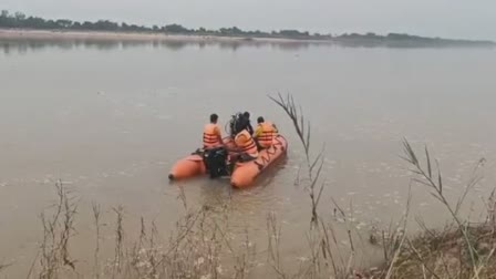 man jumps into river with his child