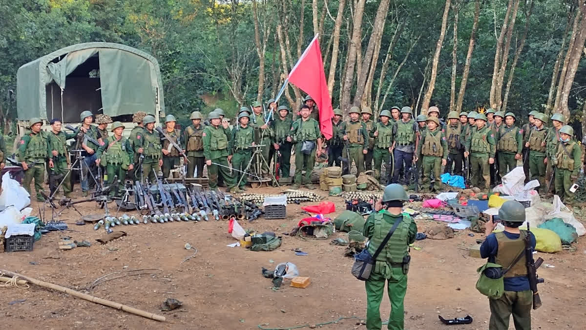 Members of the Myanmar National Democratic Alliance Army pose for a photograph with the weapons allegedly seized from the Myanmar's army outpost on a hill in Chinshwehaw town, Myanmar, Saturday Oct. 28, 2023.  (AP photo)