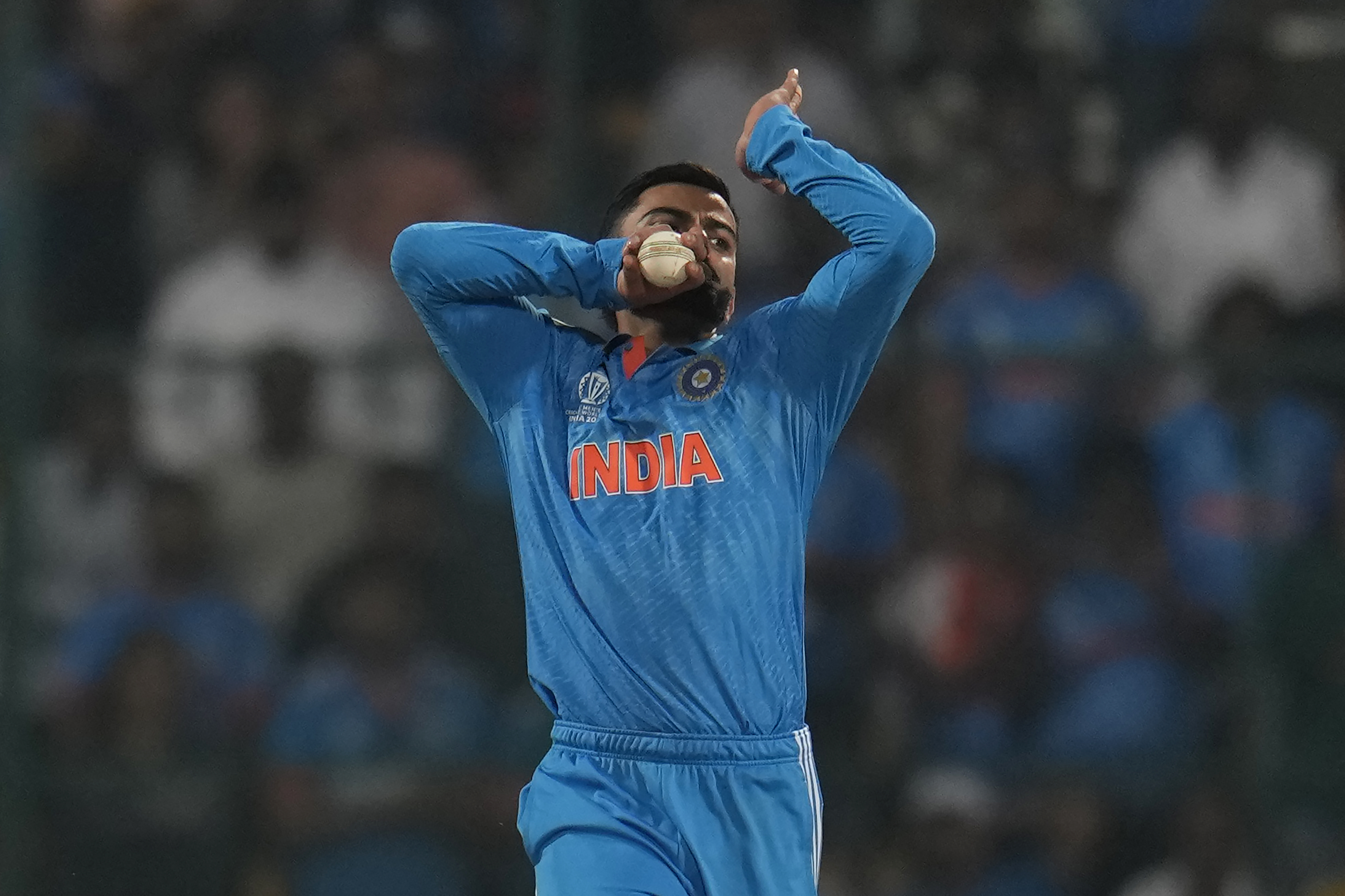 India's Virat Kohli celebrates the dismissal of Netherlands' captain Scott Edwards during the ICC Men's Cricket World Cup match between India and Netherlands in Bengaluru, India, Sunday, Nov. 12, 2023. (AP