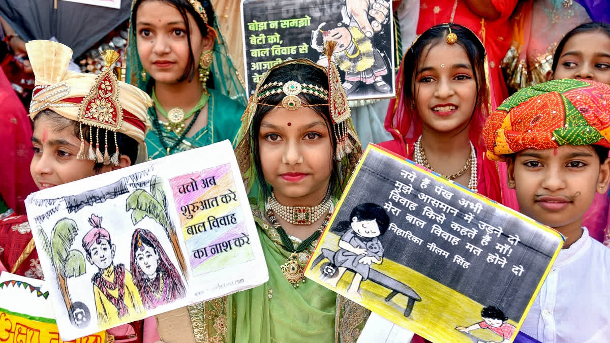 Children dressed in traditional attire take part in an awareness campaign against child marriage