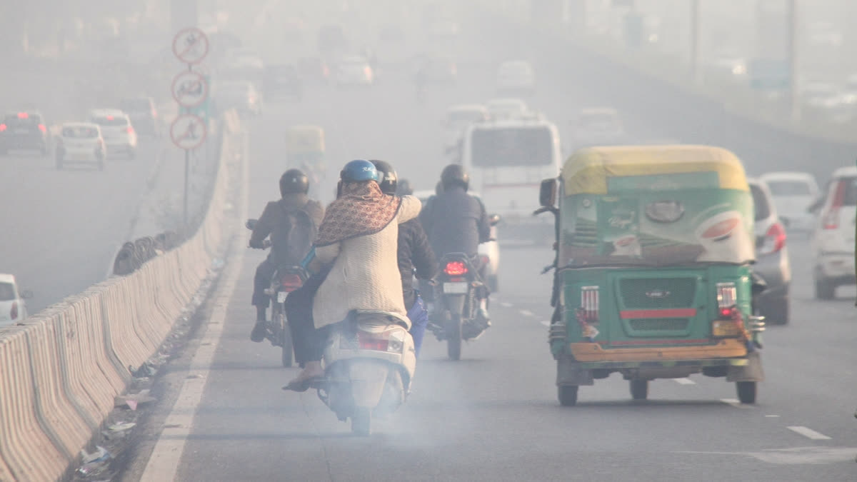 Vehicles move on a road amid low visibility due to smog in Gurugram