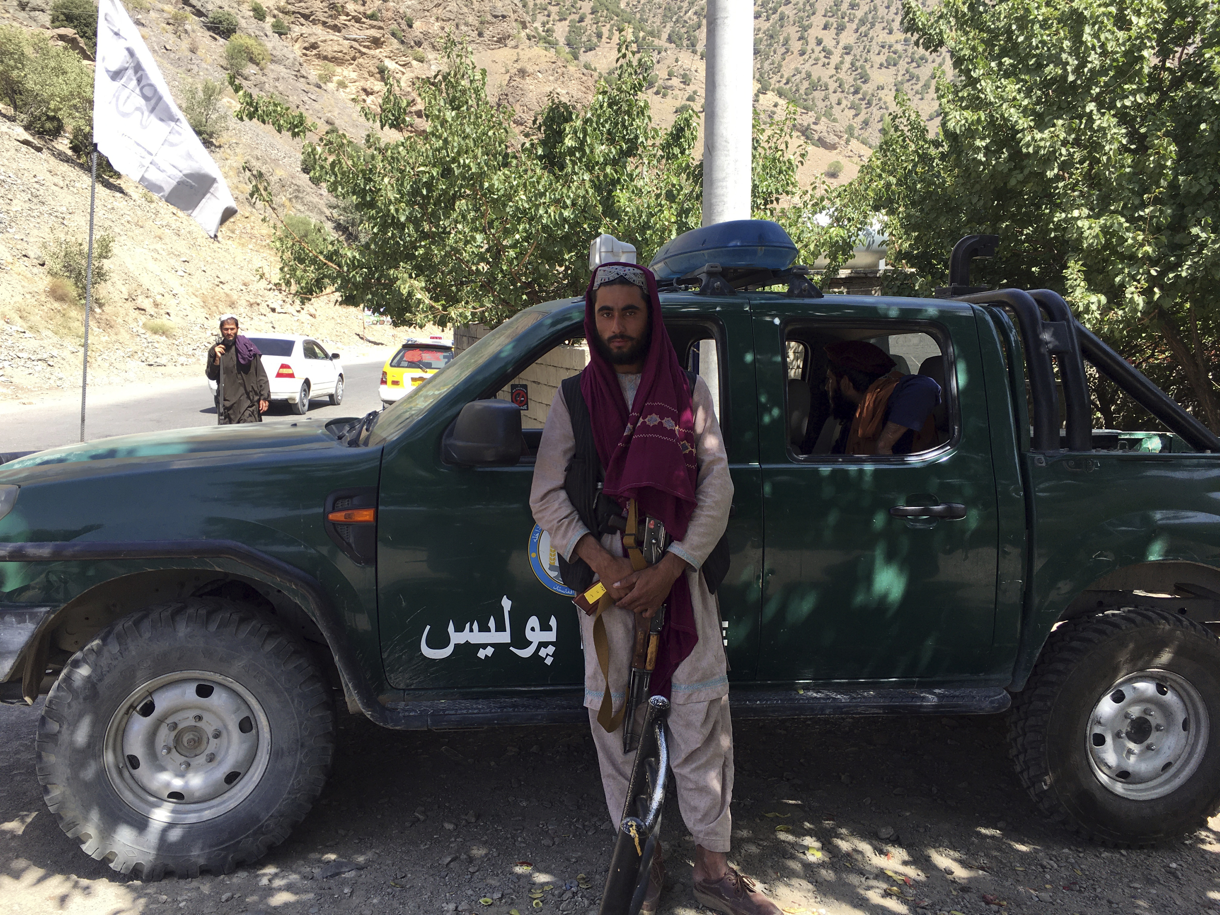 Taliban soldiers stand guard in Panjshir province