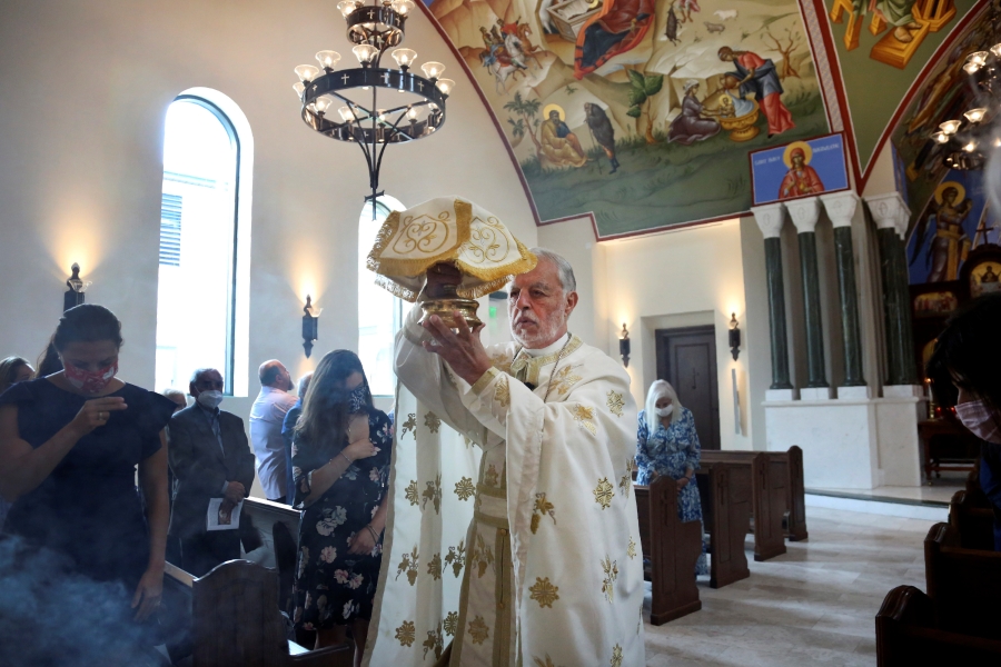 The Rev. Alex Karloutso, vicar-general for the Greek Orthodox Archdiocese of America, presides over services at the Formation of the Virgin Mary Greek Orthodox Church of the Hamptons on Sunday, Aug. 29, 2021, in Southhampton, N.Y. Karloutso was among clergy offering spiritual support to emergency responders in the hours and days after the Sept. 11, 2001 attacks and has since played a significant role in the reconstruction of St. Nicholas Greek Orthodox Church and National Shrine at ground zero.