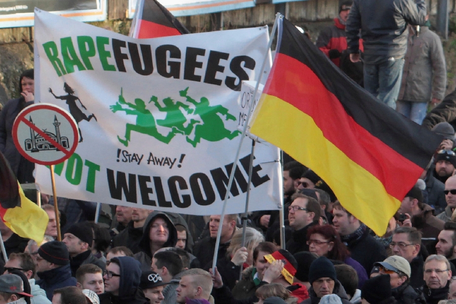 In this Saturday Jan. 9, 2016 file photo, right-wing demonstrators hold a sign which reads, 