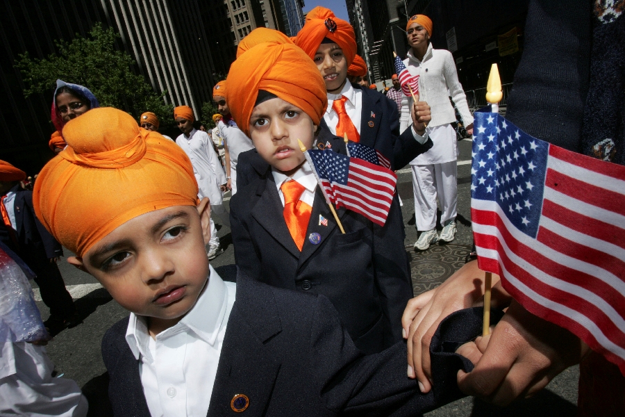 In this Saturday, April 29, 2006 photo, children holding U.S. flags march down Broadway during the 19th Annual Sikh Day Parade in New York. Since Sept. 11, 2001, many Sikhs have been mistaken for Muslims and have become targets. As a result, they have been at the forefront of civil rights advocacy against religious and racial profiling.