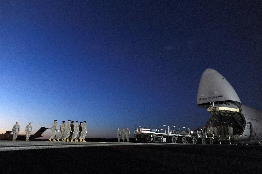 An Army carry team marches toward a transfer case containing the remains of Spc. Kyle E. Gilbert at Dover Air Force Base, Del., Wednesday, Sept. 23, 2015. According to the Department of Defense, Gilbert, 24, of Buford, Ga., died in a non-combat related incident Sept. 21, 2015 in Bagram, Afghanistan.