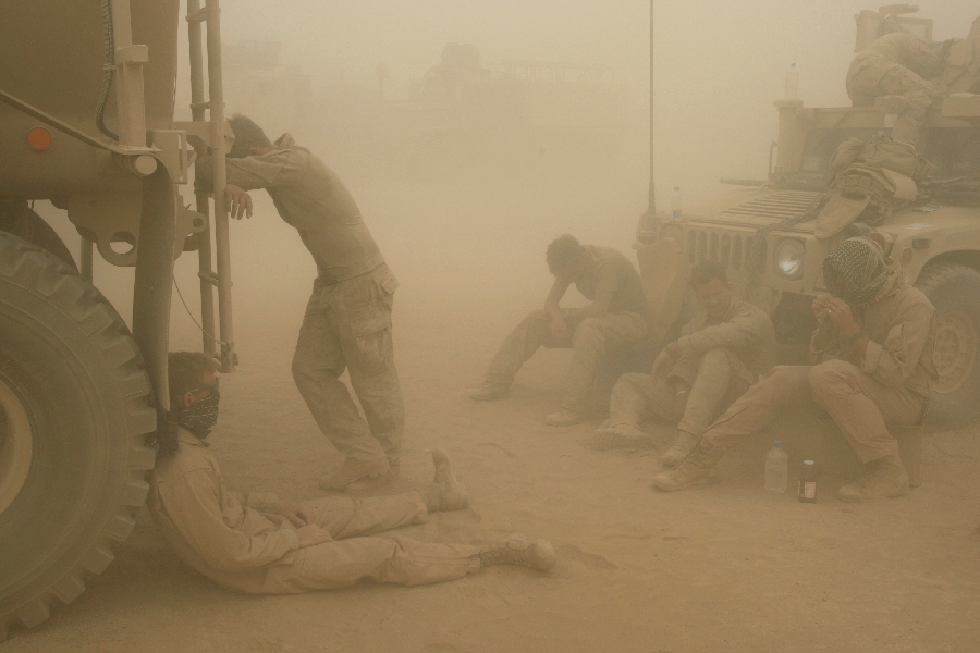 In this Wednesday, May 7, 2008 file photo, U.S. Marines from the 24th Marine Expeditionary Unit try to take shelter from a sand storm at forward operating base Dwyer in the Helmand province of southern Afghanistan.