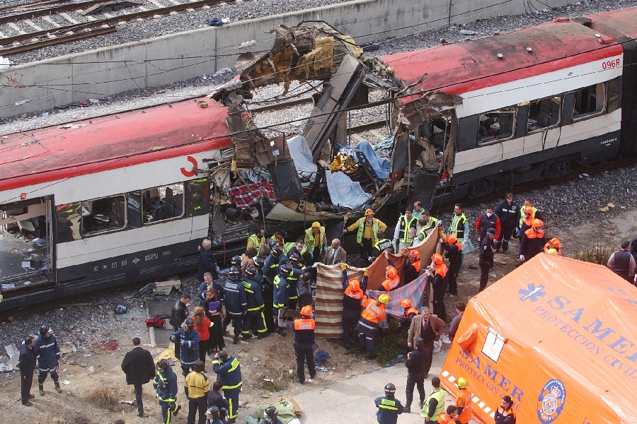 In this March 11, 2004 file photo, rescue workers cover bodies alongside a bomb-damaged passenger train, following a number of explosions in Madrid, Spain, which killed more than 170 rush-hour commuters and wounded more than 500 in Spain's worst terrorist attack ever. An Al-Qaida-linked group that claimed responsibility for the Madrid train bombings warned European nations that they have only two weeks to withdraw troops from Iraq or face the consequences, a pan-Arab newspaper reported Friday, July 2, 2004.