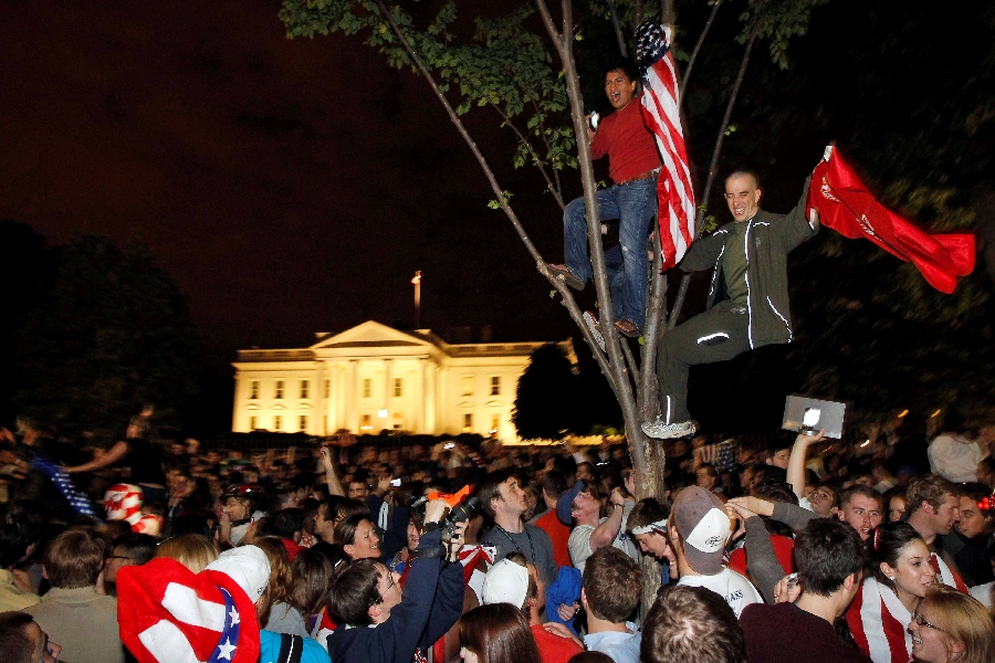 In this Monday, May 2, 2011 file photo, crowds climb trees and celebrate in Lafayette Park in front of the White House in Washington after President Barack Obama announced that Osama bin Laden had been killed.