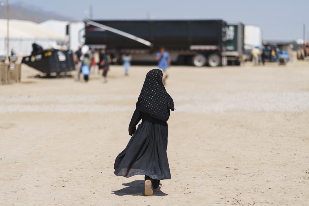 A child walks through Fort Bliss' Doña Ana Village where Afghan refugees are being housed, in New Mexico, Friday, Sept. 10, 2021.