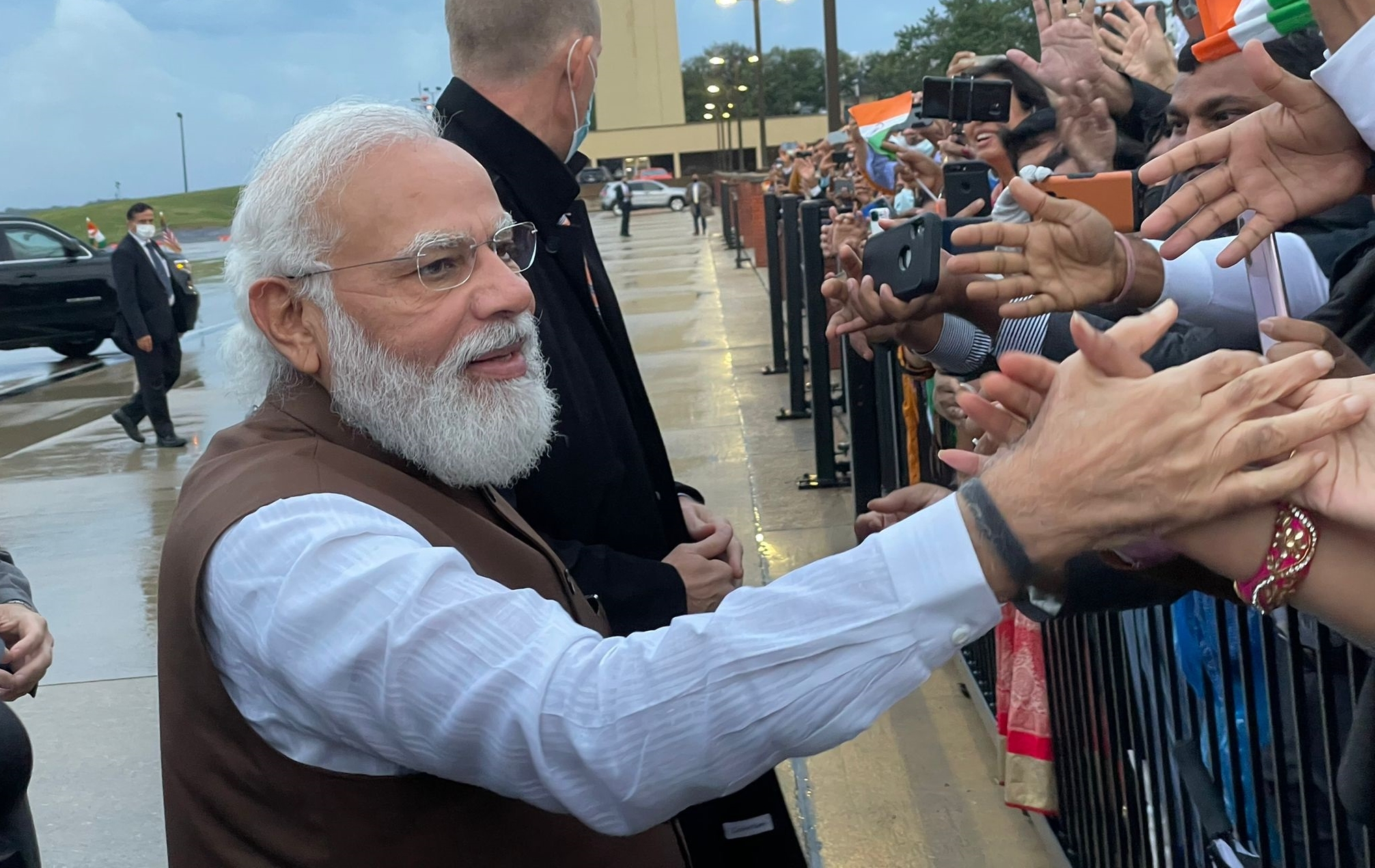 Prime Minister Narendra Modi steps out of his car to meet people who were waiting to welcome him at Joint Base Andrews in Washington DC