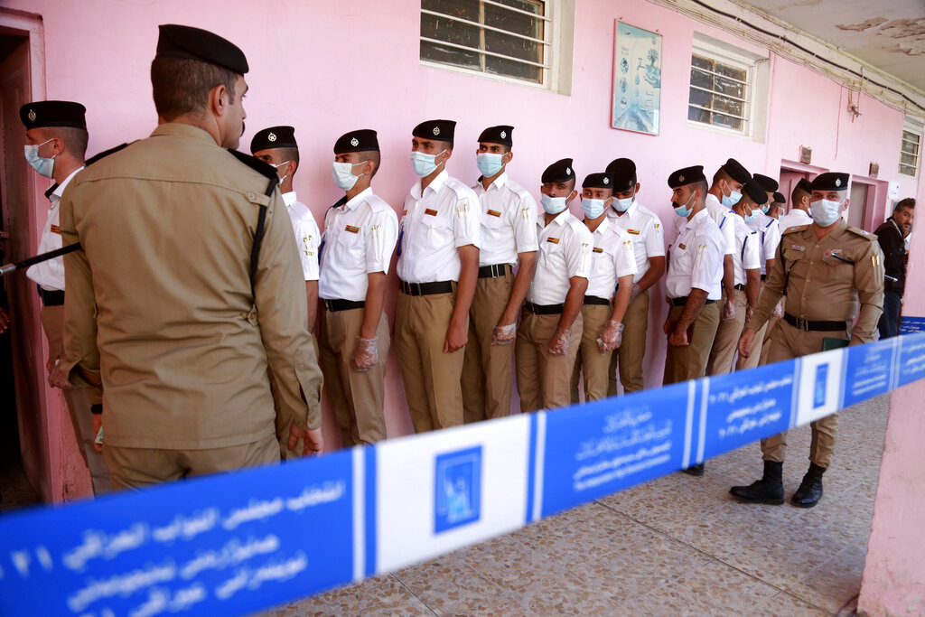 Security forces gather to vote during a special voting ahead of Sunday's parliamentary election in Baghdad, Iraq, Friday, Oct. 8, 2021.