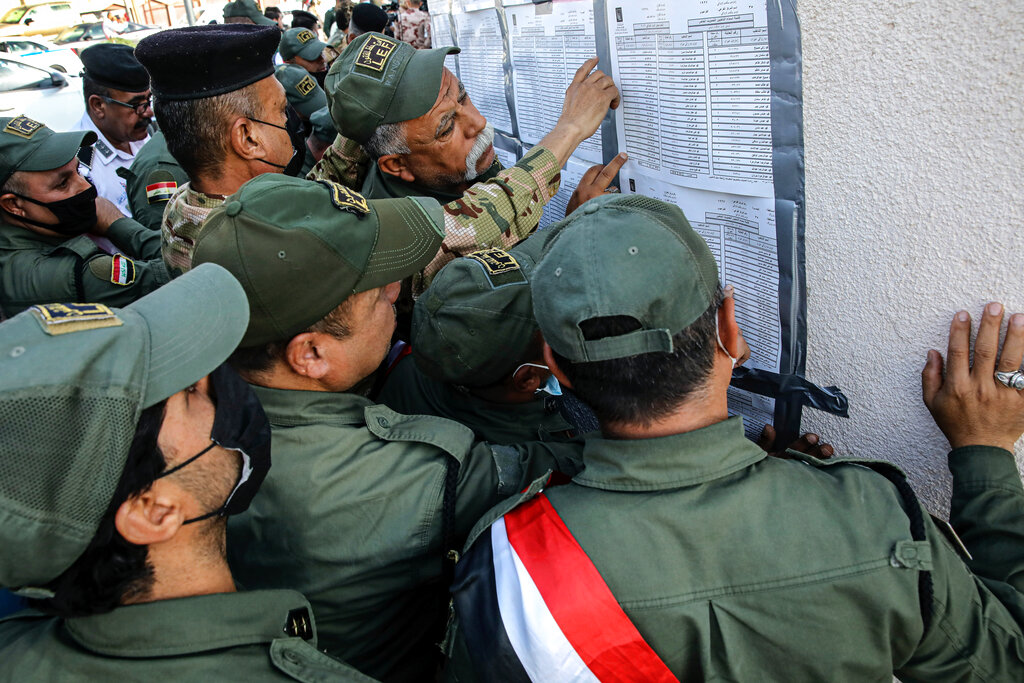 Security forces gather to vote during the early voting for security forces ahead of Sunday's parliamentary election in Basra, Iraq, Friday, Oct. 8, 2021. Iraqi security personnel across the country are casting their ballots Friday two days ahead of parliamentary election.