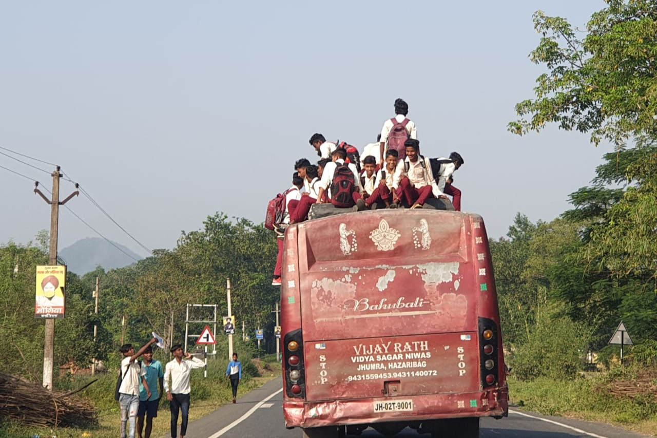 बस की छत पर बैठे स्कूली बच्चे