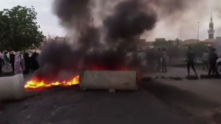 Pro-democracy protesters burn tires in the streets