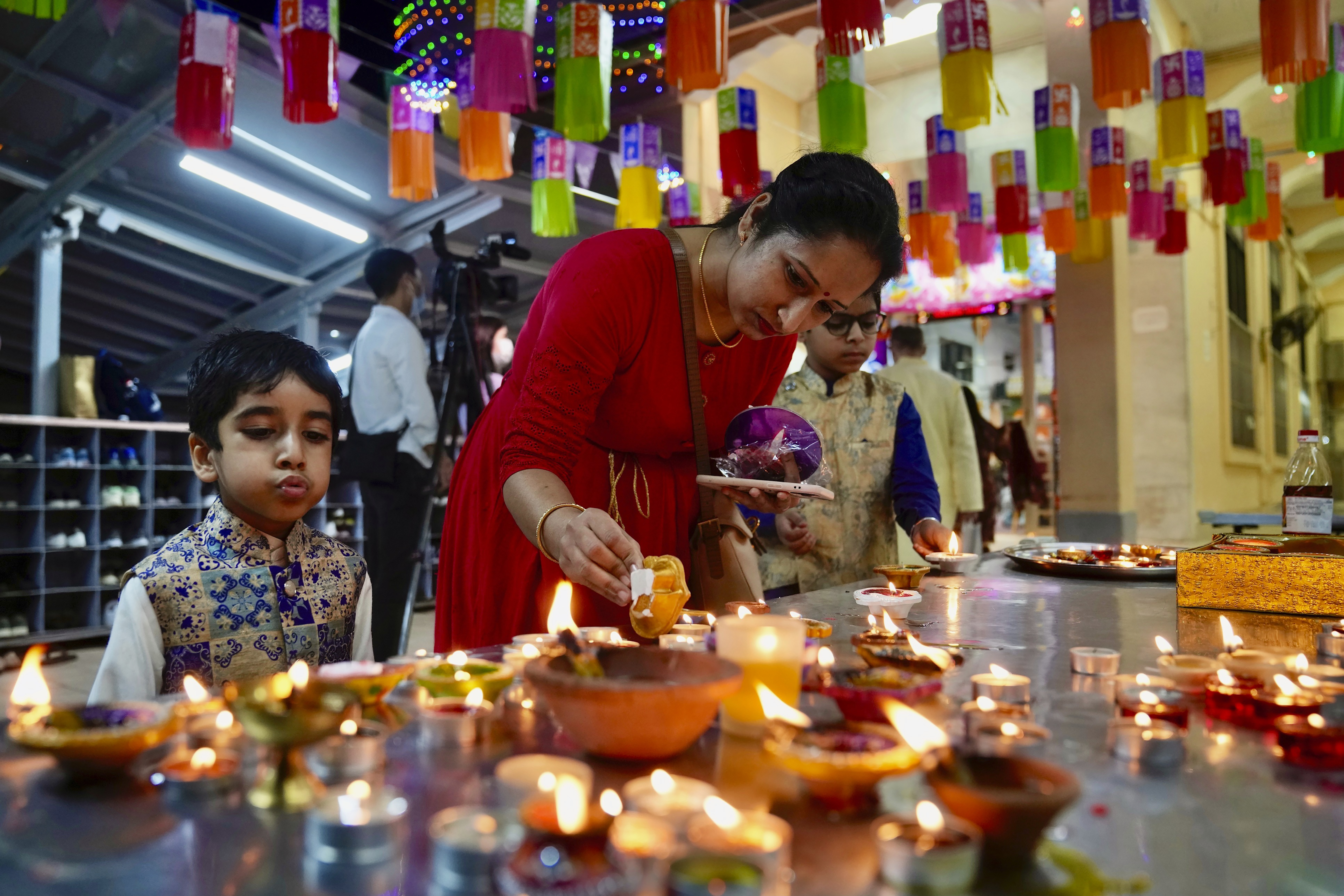 Hindu devotees light oil lamps at a temple during Diwali in Hong Kong