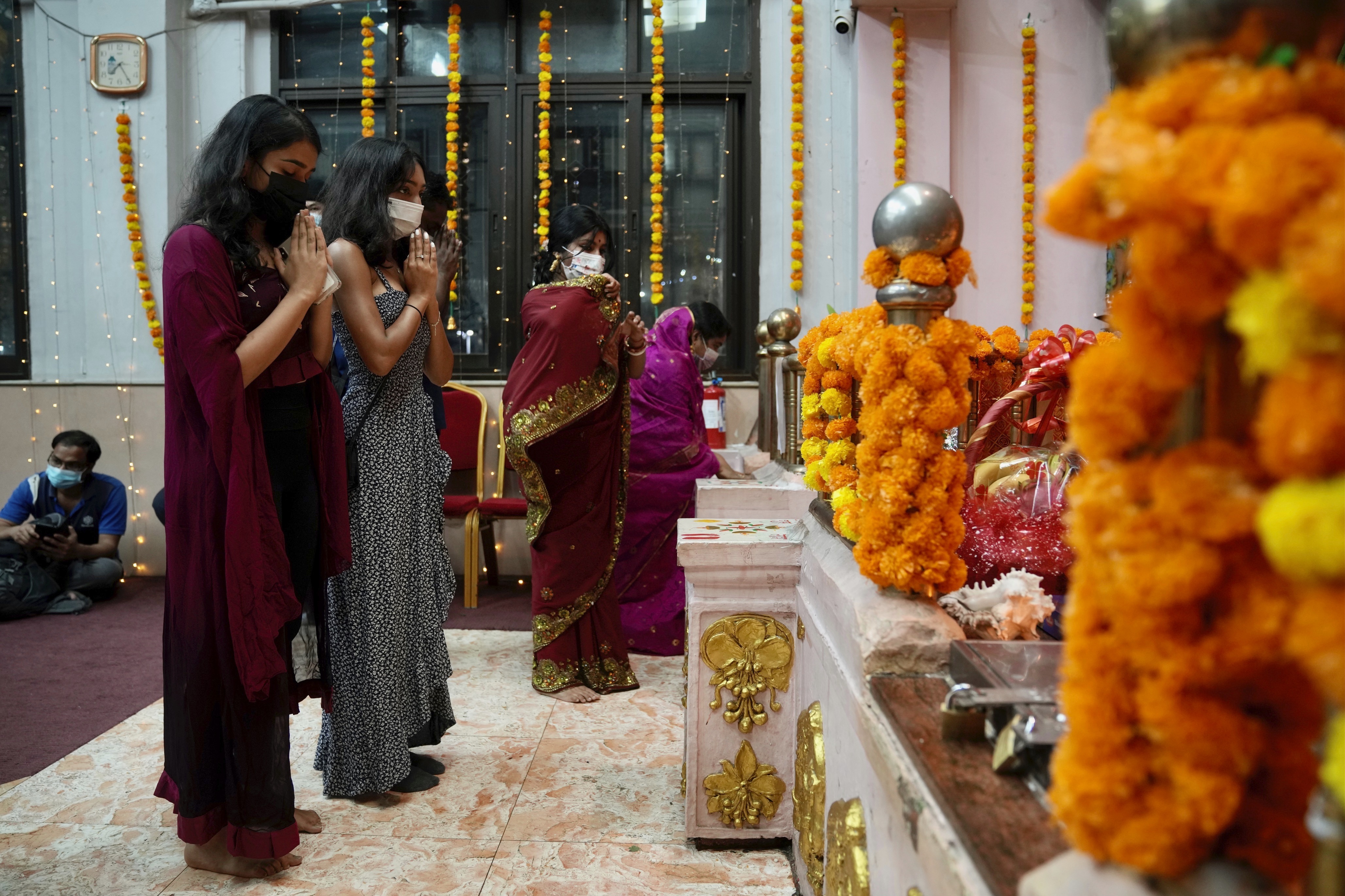 Hindu devotees pray at a temple during Diwali in Hong Kong