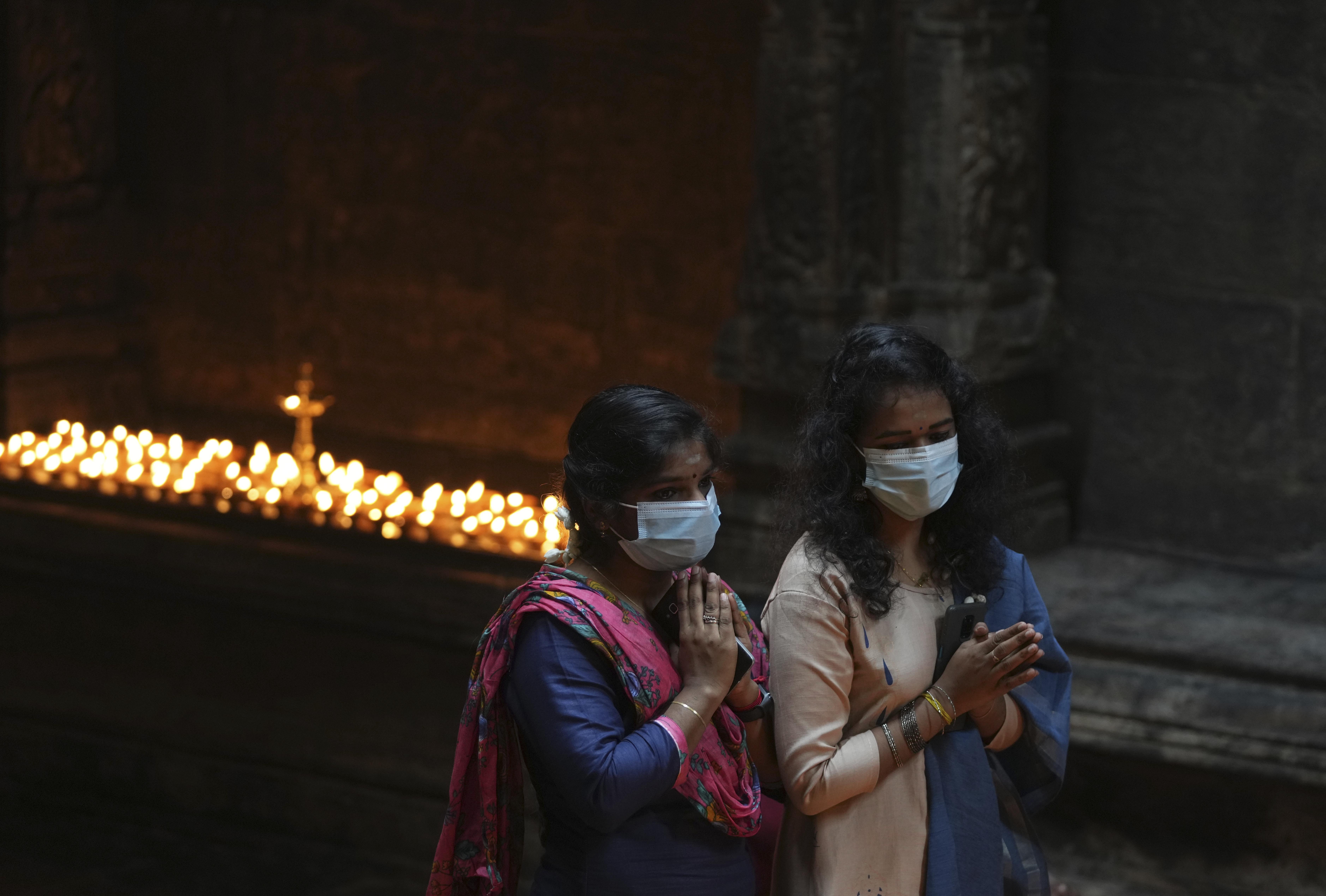 Ethnic Tamil women offer prayers during Diwali